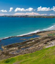 Pembrokeshire - Newgale Beach, taken from high up with a view of the whole beach. Blue water and green grassy hills