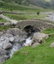 Part of the Beatrix Potter cycle route with drystone walls and a stream