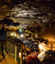 People exploring atmospheric walkways inside the Marble Arch caves