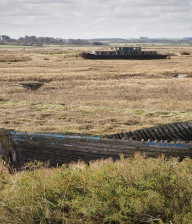 Grassland and deserted boats at Blakeney nature reserve, Norfolk