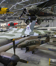 Inside an aircraft hangar filled with wartime aeroplanes at Duxford Museum