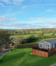 Aerial view of a lodge with decking at Juliots Well Holiday Park, Cornwall