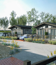 Luxury lodges overlooking landscaped pathway at Pinewood Retreat Holiday Park