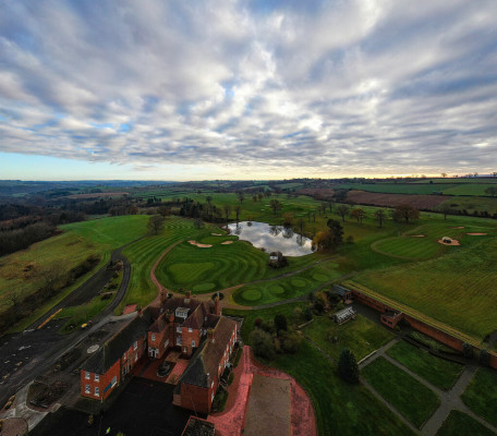 Panoramic aerial shot of the Astbury grounds, lake and golf course